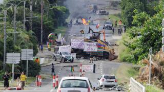 Noumea, France. 23rd May, 2024. Protesters wave Kanak flags at an independantist roadblock in Avenue d'Auteuil in Noumea, France's Pacific territory of New Caledonia, on May 22, 2024. French security forces will remain in New Caledonia as long as necessar