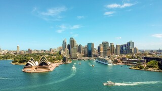 Stunning wide angle aerial drone view of the Sydney Harbour with the Opera House, a cruise ship and many skyscrapers in the background. Taken near the suburb of Kirribilli. New South Wales, Australia.