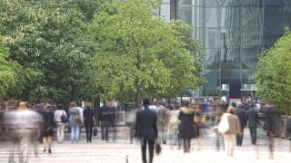 Business people walking in a financial district commuters trees green.jpg