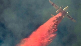 air-tanker-makes-a-drop-from-above-to-save-home-from-flair-up-winds-of-the-woolsey-fire-pa-39659554-web.jpg