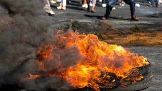 Protesters protest riot burning rubber tyres South Africa.jpg