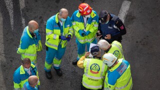 Group of paramedics and police in a circle during an intervention in a traffic accident