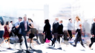 Walking people blur. Lots of people walking in the City of London. Wide panoramic view of people crossing the road.