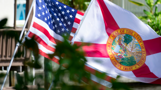 American and Florida flags waving.png