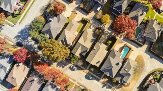Aerial view urban subdivision houses with pool and autumn leaves near Dallas