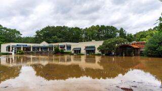 A shopping center is surrounded by flood water from Hurricane Helene Friday, Sept 27, 2024, in Atlanta. (AP Photo/Jason Allen)