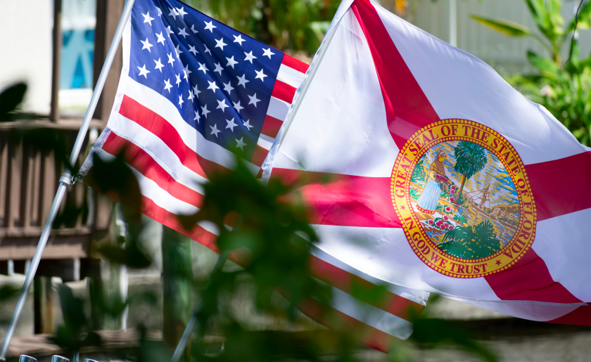 American and Florida flags waving.png