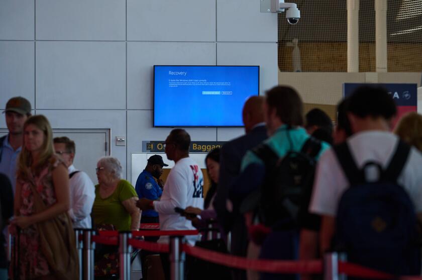 New York, New York, USA. 19th July, 2024. A screen at JFK Airport Terminal 1 displays a blue recovery mode message after a faulty Microsoft update by the cybersecurity company, Crowdstrike led to widespread computer outages, grounding numerous flights. (C