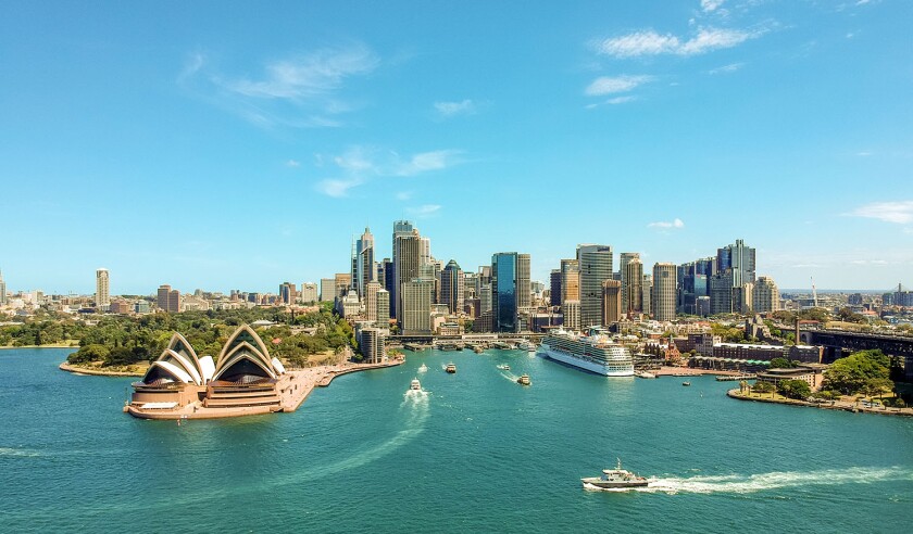 Stunning wide angle aerial drone view of the Sydney Harbour with the Opera House, a cruise ship and many skyscrapers in the background. Taken near the suburb of Kirribilli. New South Wales, Australia.