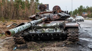 2022-04-09 Kyiv region, Ukraine. Destroyed russian tank with Wolverines painting stucked in the mud on the E40 highway near Kyiv. War in Ukraine
