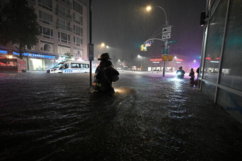 New York City, USA. 01st Sep, 2021. Members of the FDNY wade through waist high water caused by flash flooding brought by the remnants of hurricane Ida, in the New York City borough of Queens, NY, September 1, 2021. More than three inches of rain fell per