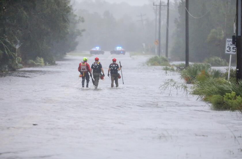Steinhatchee, Florida, USA. 30th Aug, 2023. Rescue workers with Tidewater Disaster Response wade through a tidal surge on SW 358 Hwy while looking for people in need of help where the Steinhatchee River remained out of its banks on Wednesday, Aug 30, 2023