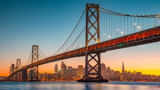 San Francisco skyline with Oakland Bay Bridge at sunset, California, USA