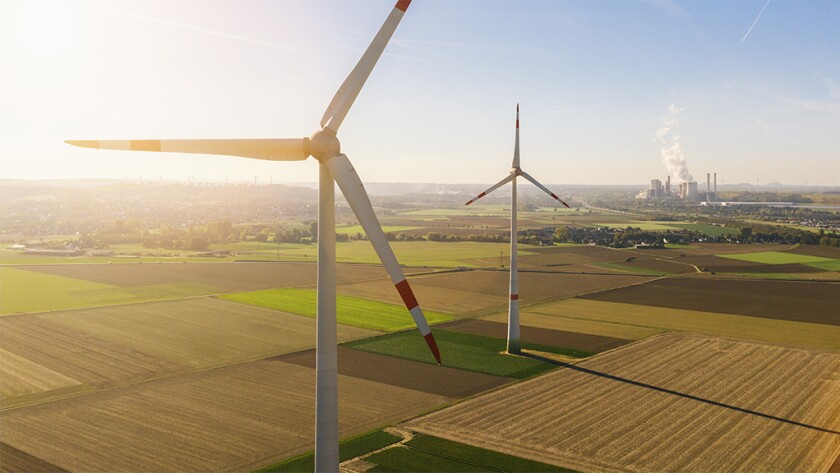 Wind turbine with coal power plant view from drone.jpg