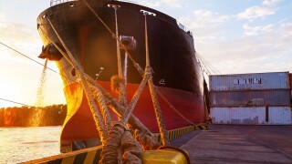 cargo ship hull A cargo ship moored to the mooring bollard of the seaport.jpg