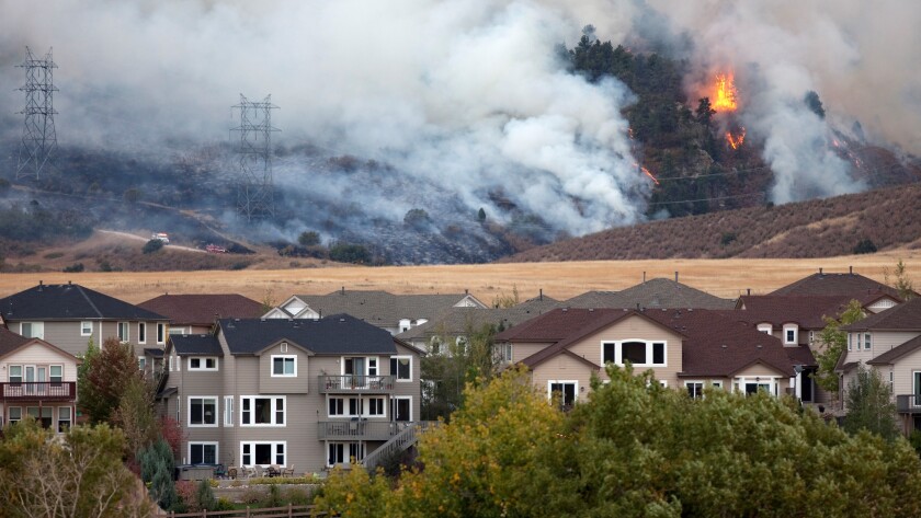 Colorado wild fire burns behind homes