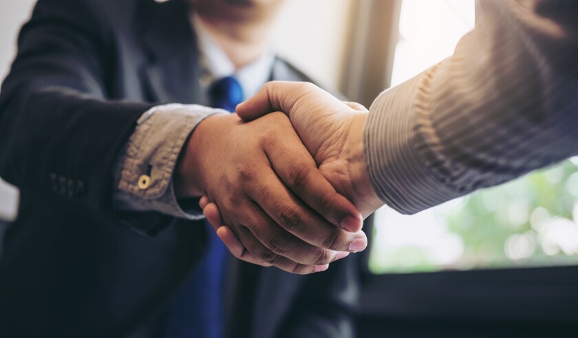 Two business men shaking hands during a meeting to sign agreement and become a business partner, enterprises, companies, confident, success dealing, contract between their firms