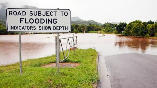 sign signal australia flood disaster rain road street tropics river water