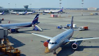 Moscow, Russia airport apron and leased Aeroflot Airbus A320-214 with an offshore registration from Bermuda.jpg