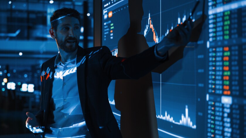 PE Business Conference Meeting Presentation: Businessman does Financial Analysis talks to Group of Businessspeople. Projector Screen Shows Stock Market Data, Investment Strategy, Revenue Growth