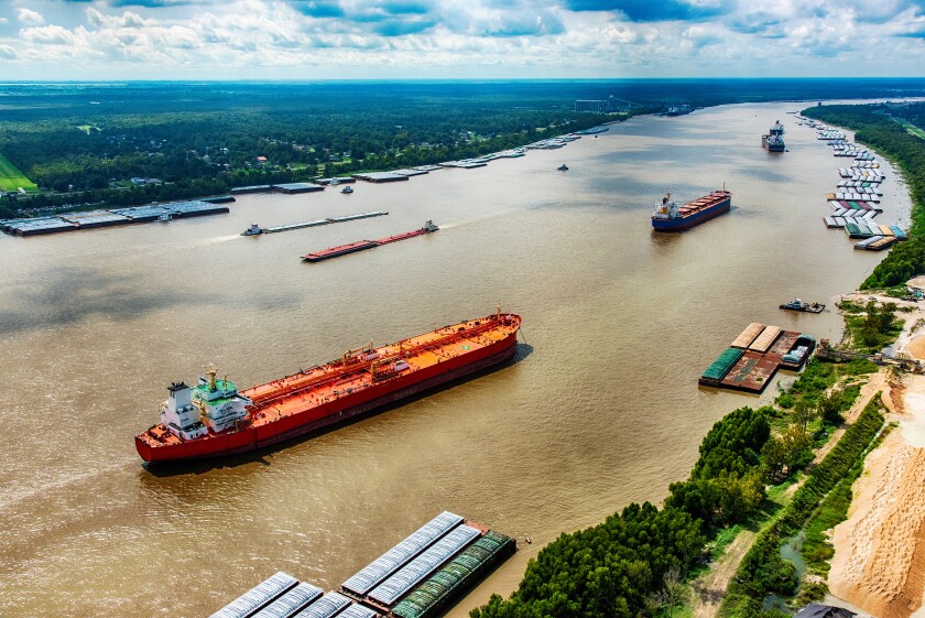 A line of oil tankers transporting fuel to the refineries located along the Mississippi River just north of New Orleans, Louisiana.jpg