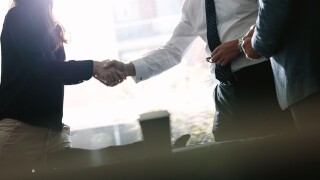 Business associates shaking hands after a deal in meeting. Business people hand shake and greeting each other after an agreement.
