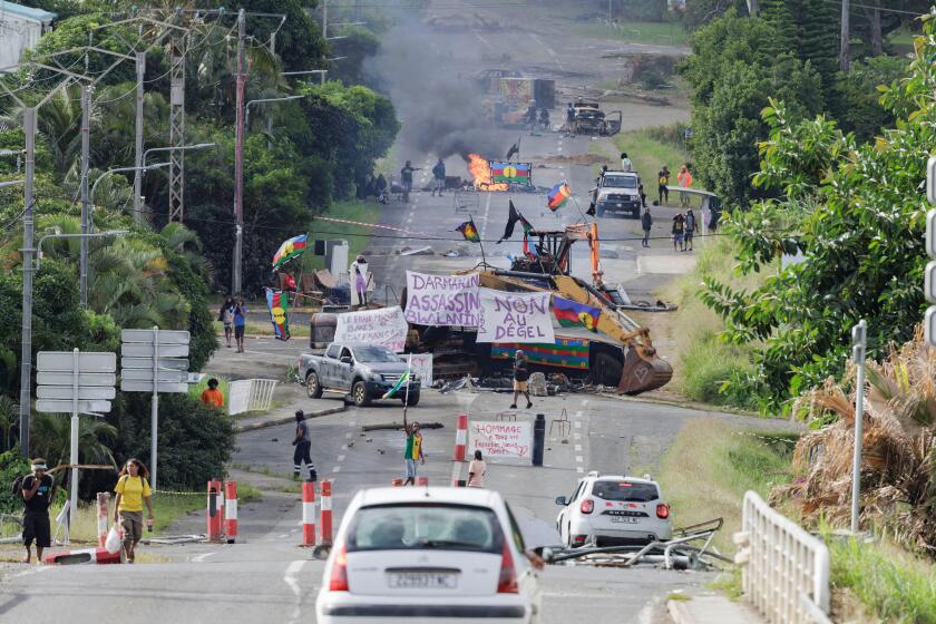 Noumea, France. 23rd May, 2024. Protesters wave Kanak flags at an independantist roadblock in Avenue d'Auteuil in Noumea, France's Pacific territory of New Caledonia, on May 22, 2024. French security forces will remain in New Caledonia as long as necessar