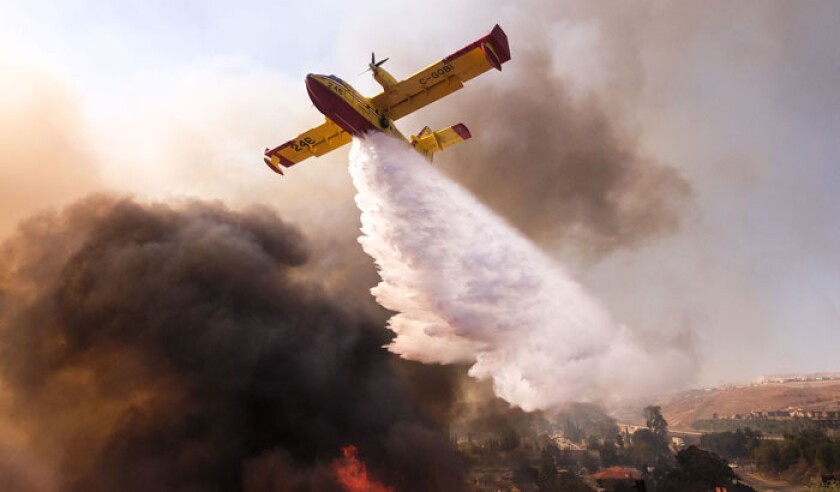 a-small-plane-makes-a-drop-on-the-wildfire-near-a-freeway-in-simi-valley-california-the-united-states-on-nov-12-2018-the-fire-in-southern-california-pa-39680012-web.jpg