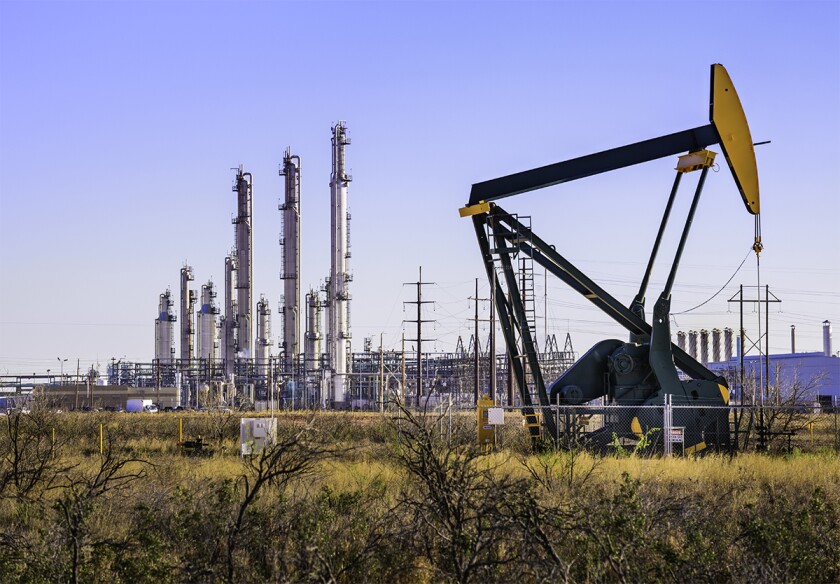 Pumpjack oil derrick and refinery plant in West Texas.jpg