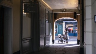 Woman leaving Greenwich Market, South East London with baby stroller.jpg