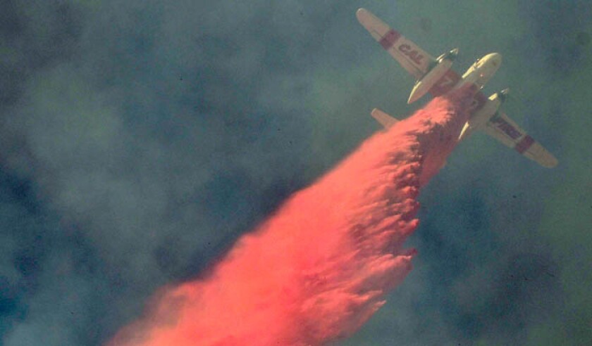 air-tanker-makes-a-drop-from-above-to-save-home-from-flair-up-winds-of-the-woolsey-fire-pa-39659554-web.jpg