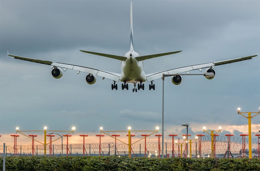 Plane landing airport evening.jpg