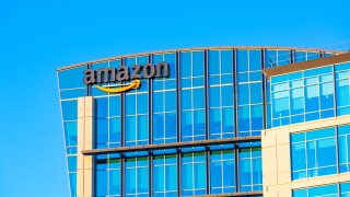 Amazon logo, sign its signature orange smile on the glass exterior of Amazon.com office in Silicon Valley - Sunnyvale, California,.jpg