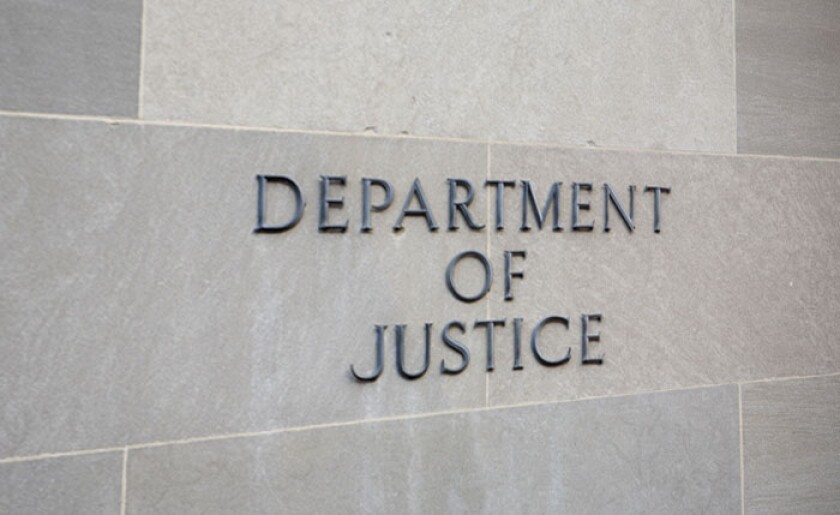 Department of Justice sign on wall.jpg