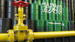 Oil pipe line valve in front of  Saudi Arabia flag