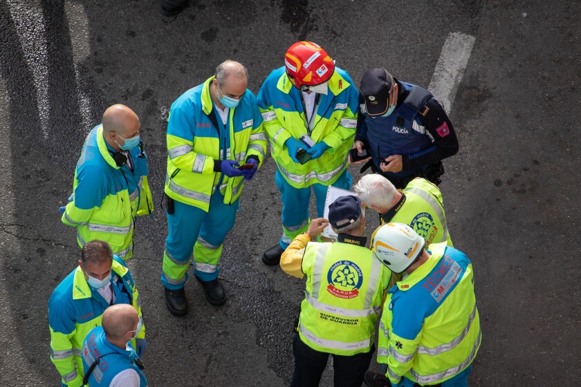 Group of paramedics and police in a circle during an intervention in a traffic accident