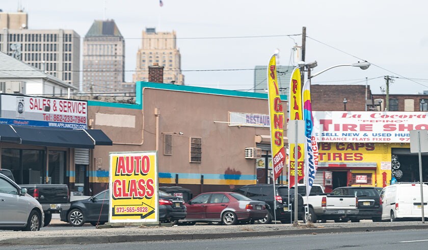 Downtown city and road highway in New Jersey with auto glass store and tire shop.jpg