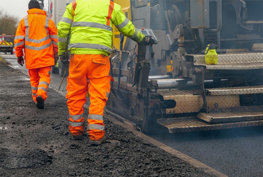 Two construction workers carrying our roadworks employees.jpg