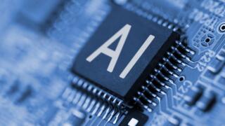 Close- up of computer chip with AI sign. Artificial intelligence.
