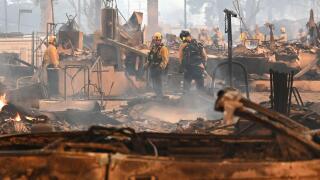 Firefighters work inside a burned structure while battling the Eaton Fire, Wednesday, Jan. 8, 2025, in Altadena, Calif. (AP Photo/Nic Coury)
