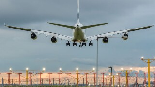 Plane landing airport evening.jpg