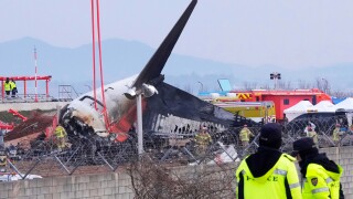 Rescue team members work at the site of a plane fire at Muan International Airport in Muan, South Korea, Monday, Dec. 30, 2024. (AP Photo/Ahn Young-joon) - Image ID: 2S0XE81