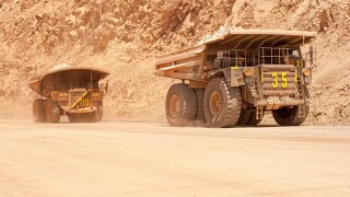 Huge large dump trucks at an open-pit copper mine in Peru.