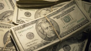 US Currency: Wads of US bills fastened with rubber bands, close-up