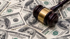 wooden hammer on dollar. close up